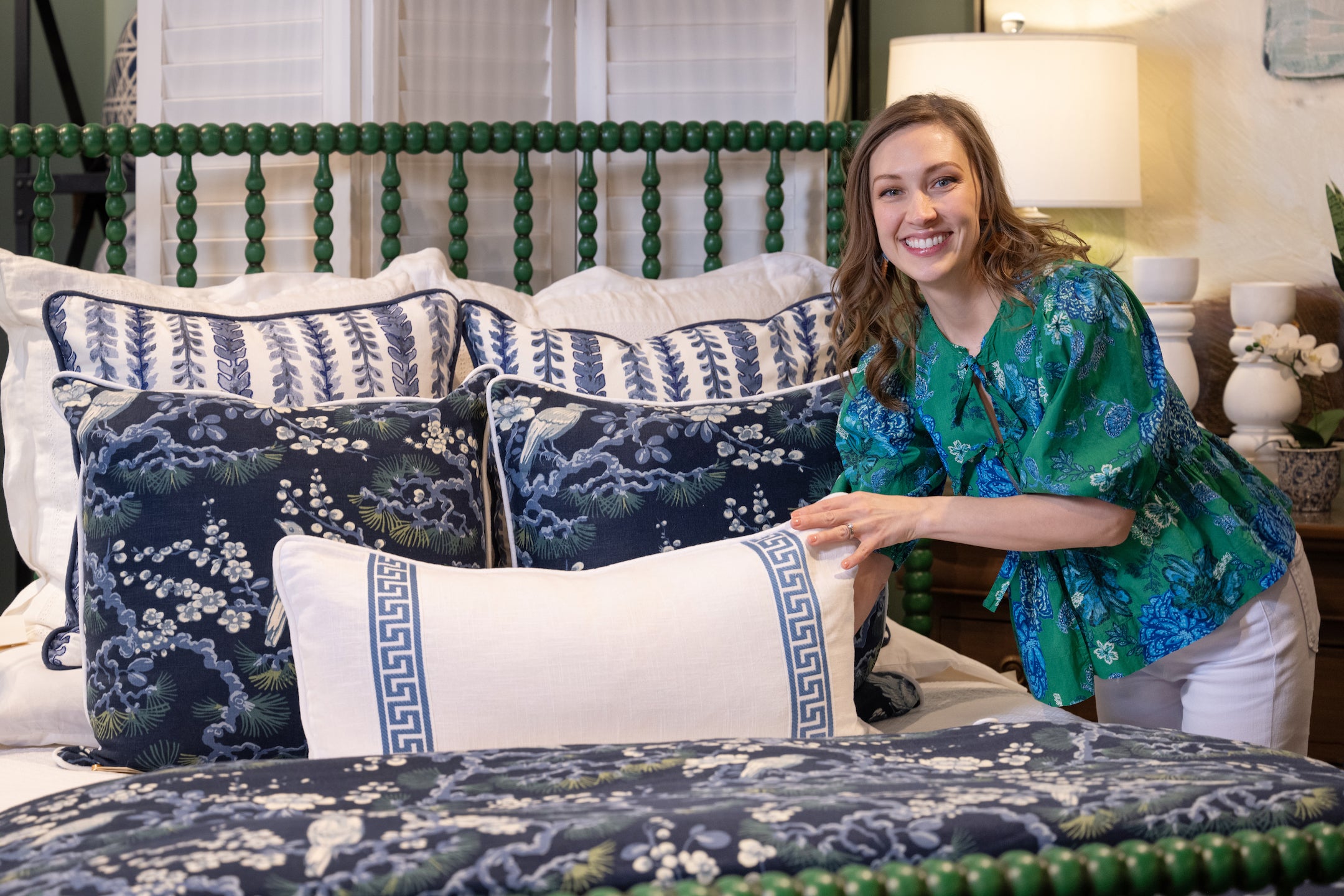 Katie poses with pillow fluffing bed