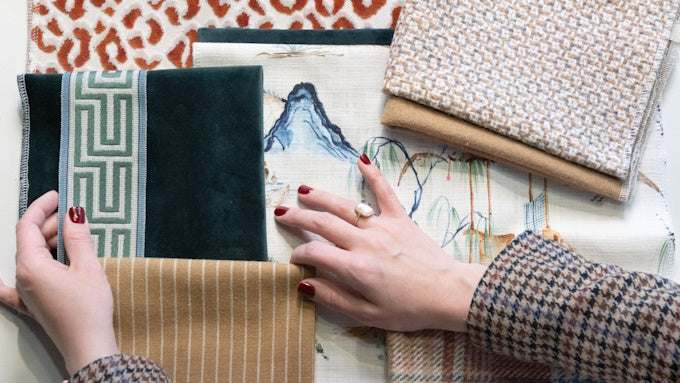woman holding flatlay options for different patterned and colored cloth samples