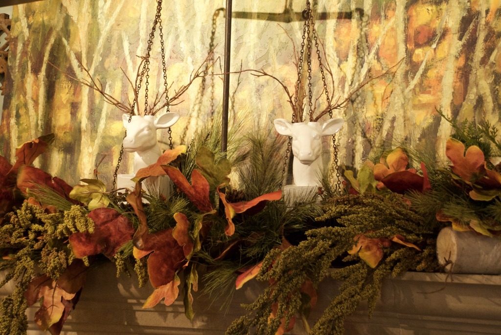 A pair of deer peek out from the foliage in the fall mantel at Nell Hill's. 