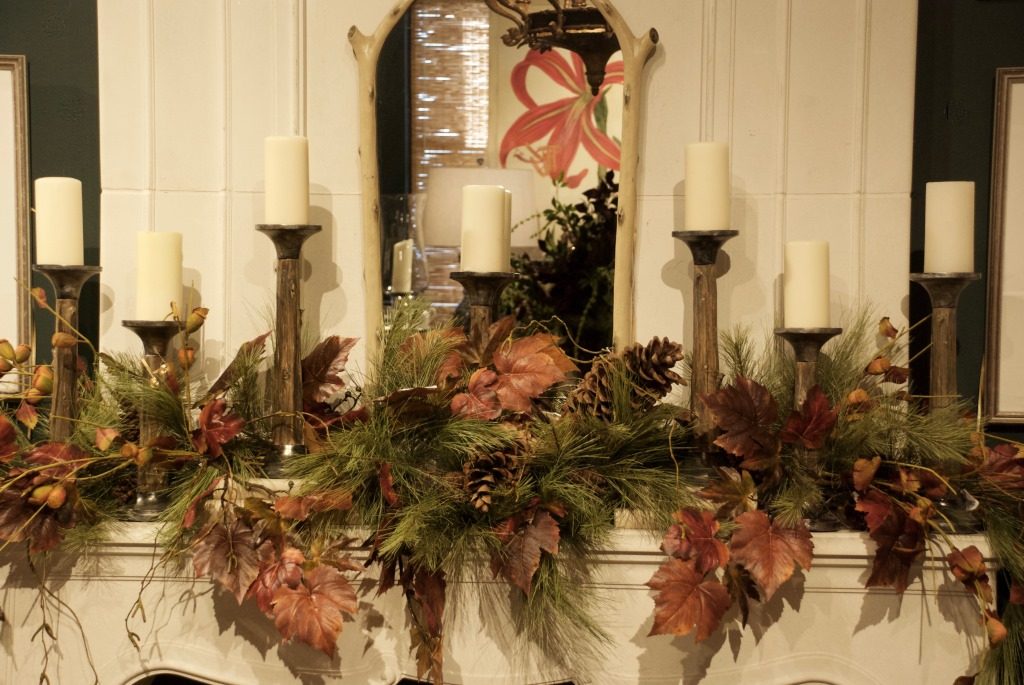 A phalanx of candles give warmth to this fall mantel at Nell Hill's.