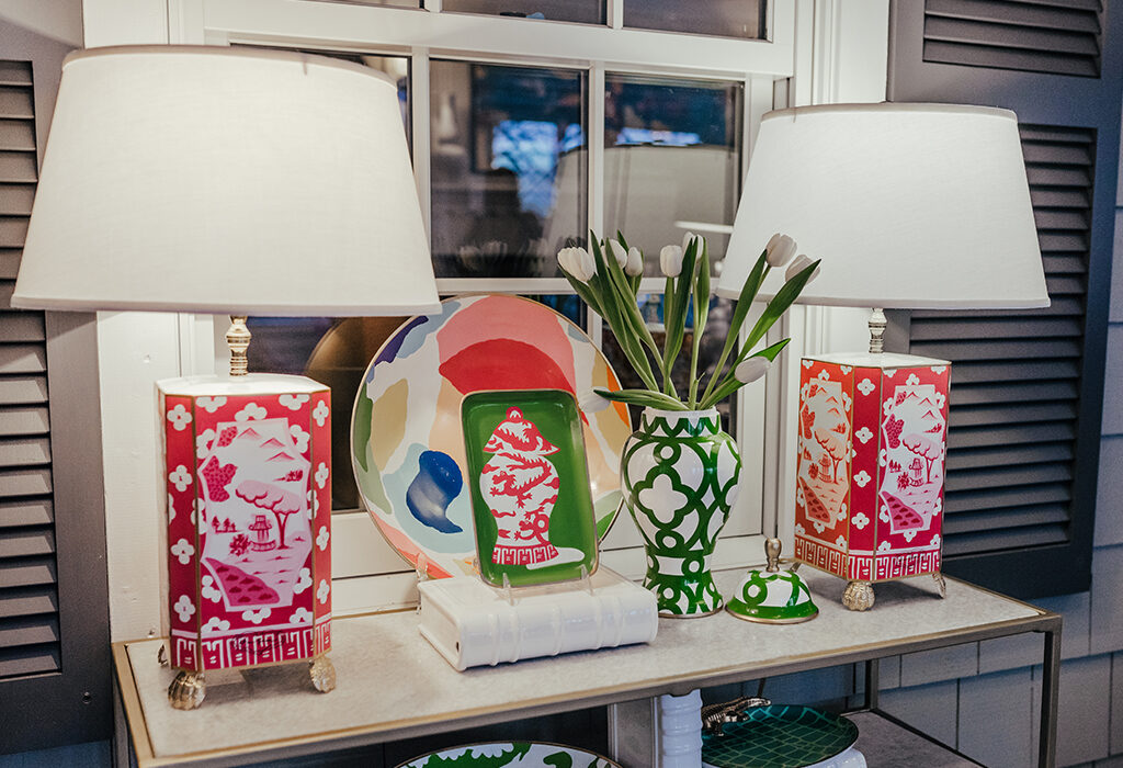 Two lamps are sometimes better than one.  These bright pink lamps act as bookends for the table and compliment the green and white accents. 