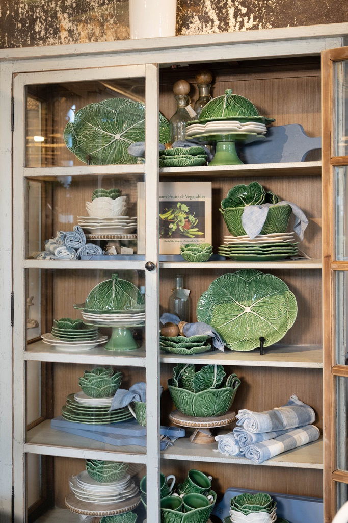 Blue accents paired with a cabinet full of cabbage ware